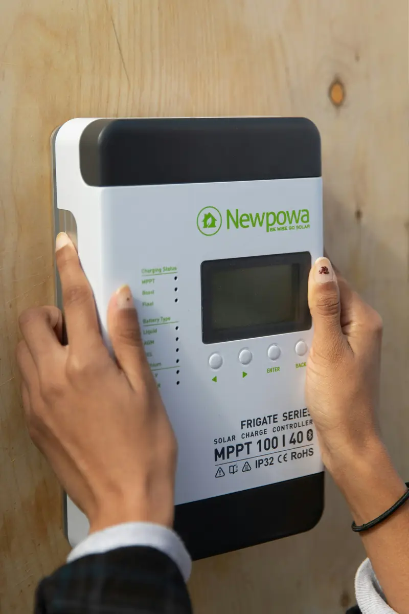Technician checking a solar charge controller display